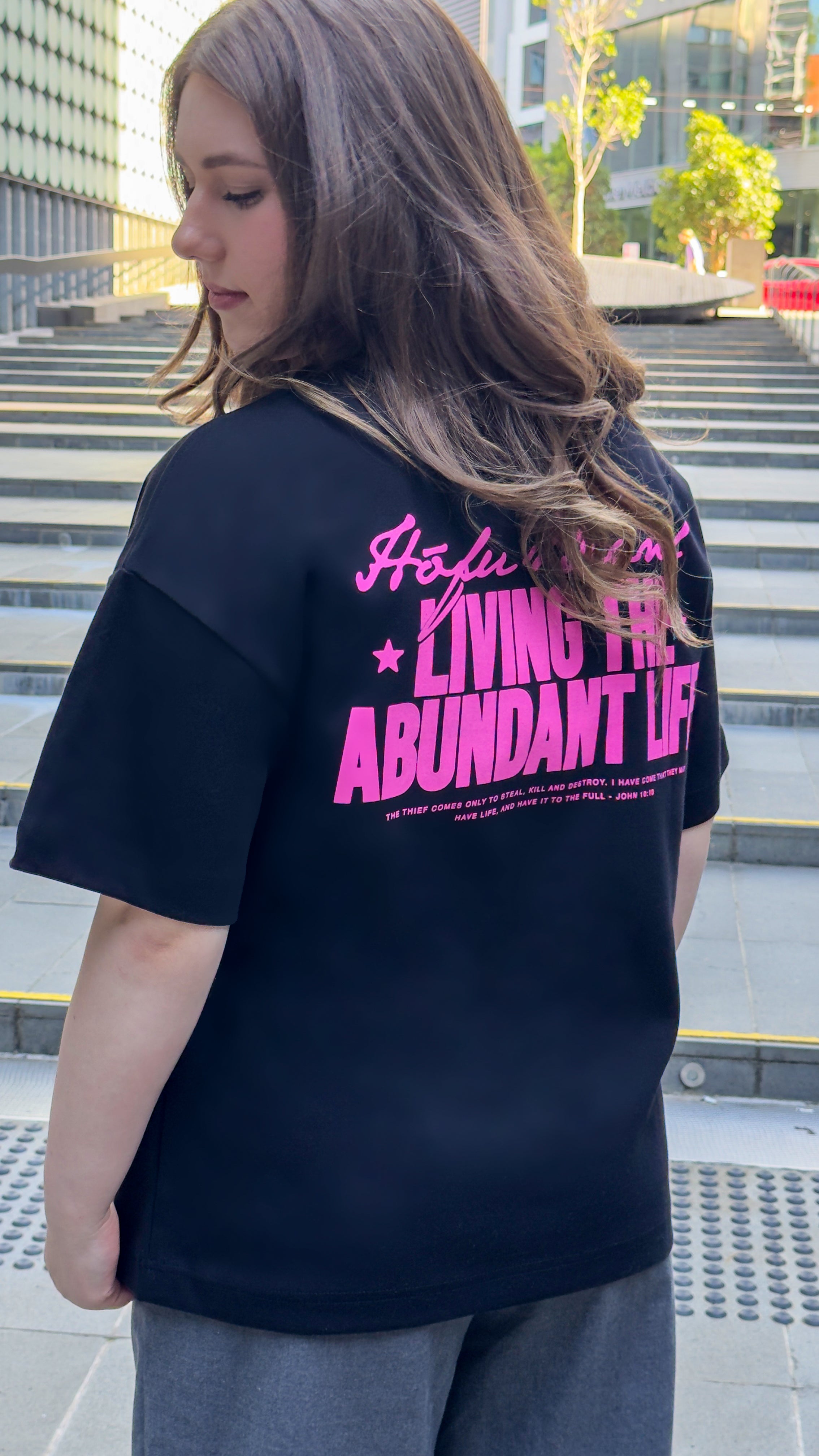 LIVING THE ABUNDANT LIFE TEE PINK ON BLACK