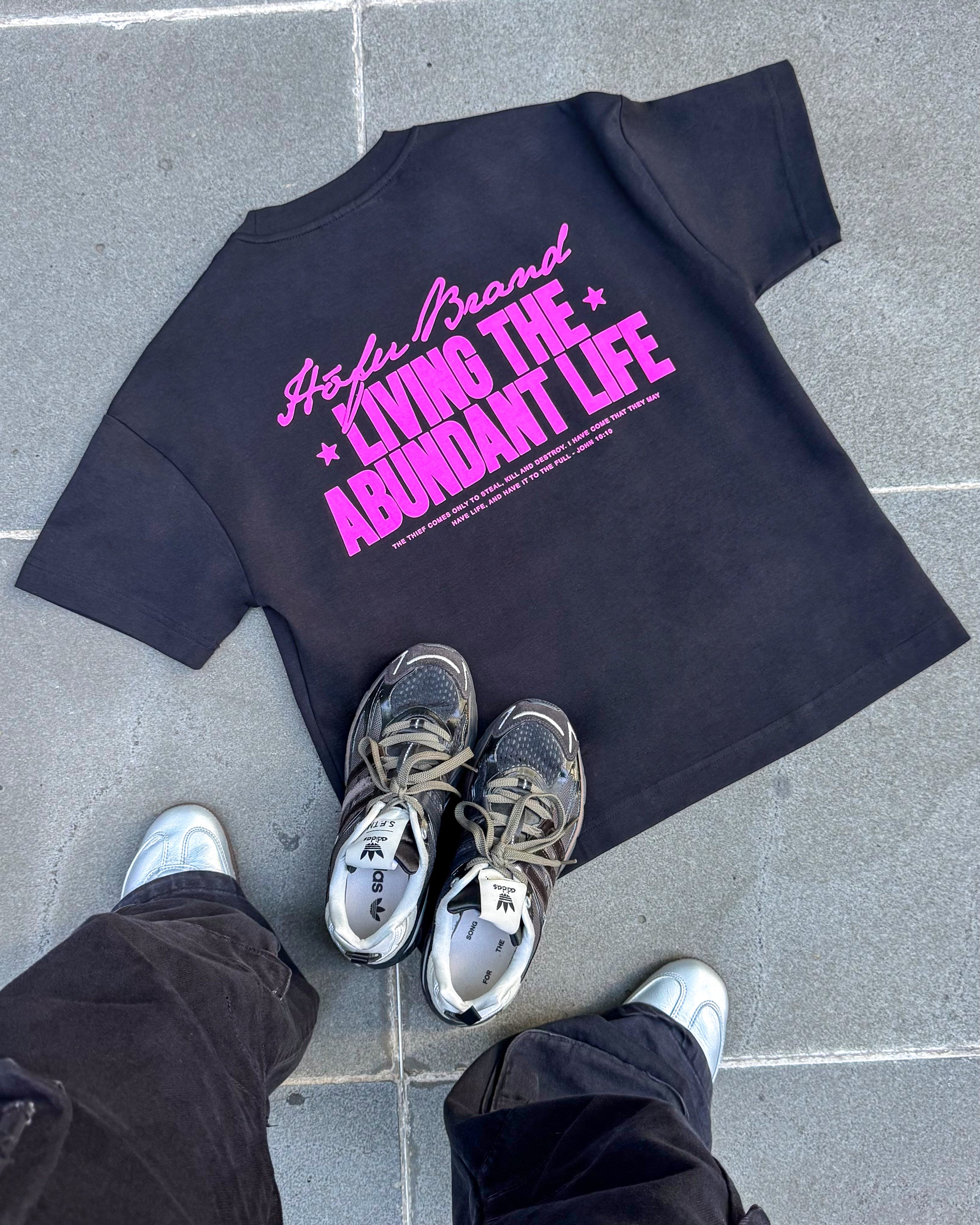 LIVING THE ABUNDANT LIFE TEE PINK ON BLACK