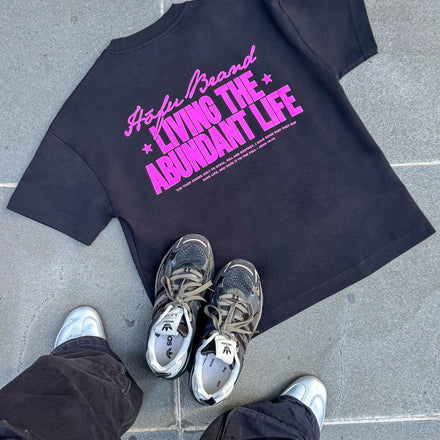 LIVING THE ABUNDANT LIFE TEE PINK ON BLACK